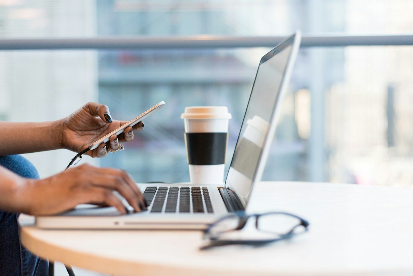 Person managing payments securely on a laptop and phone
