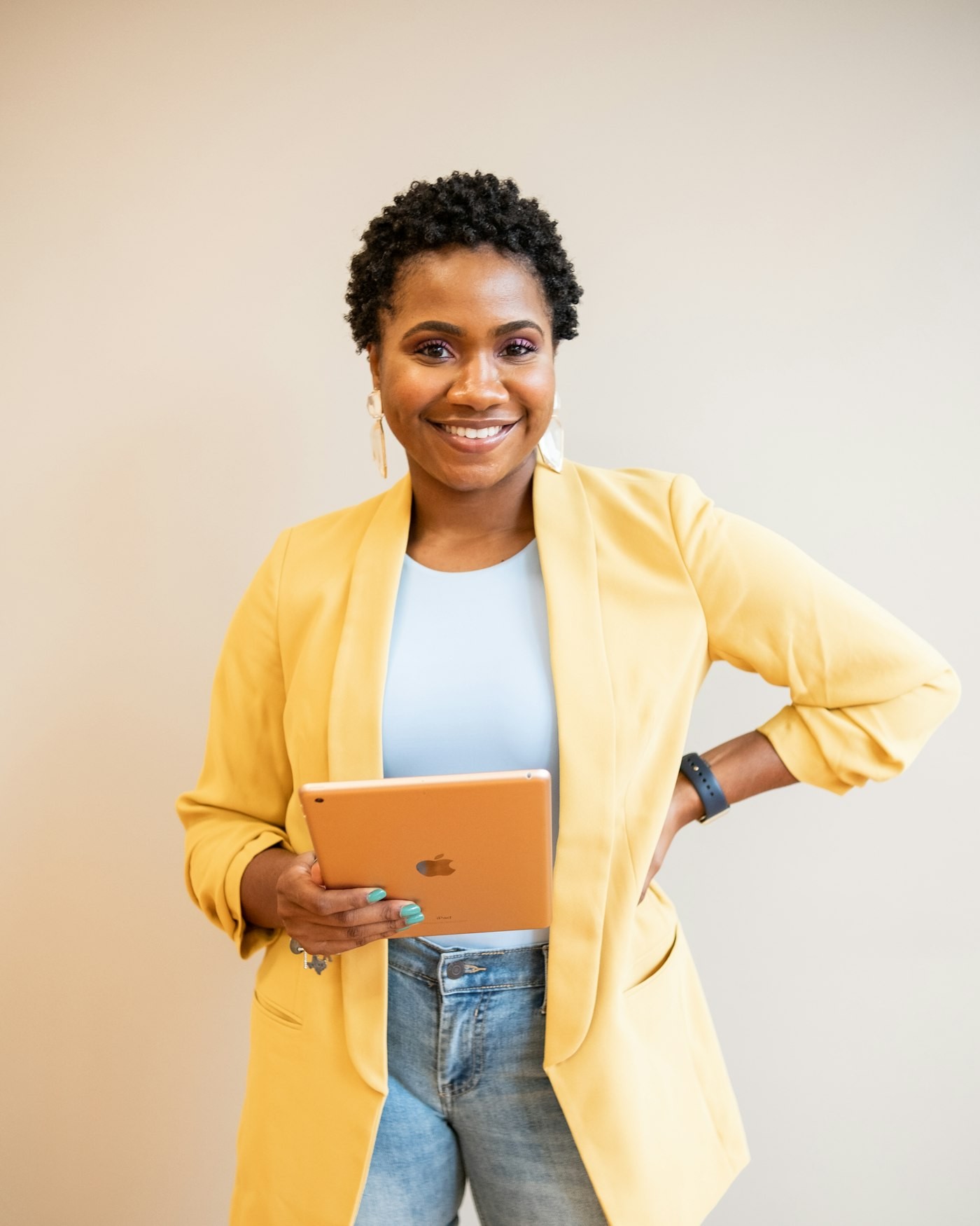 Business owner smiling while holding a tablet